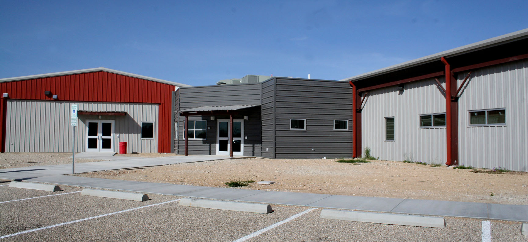 An L-shaped building featuring dark red, light and dark gray colors serves as the new Kerr County Animal Control site.